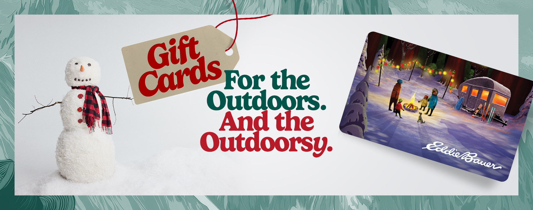 A woman with long dark hair uses her hands to makes a heart symbol against the trunk of a tree.