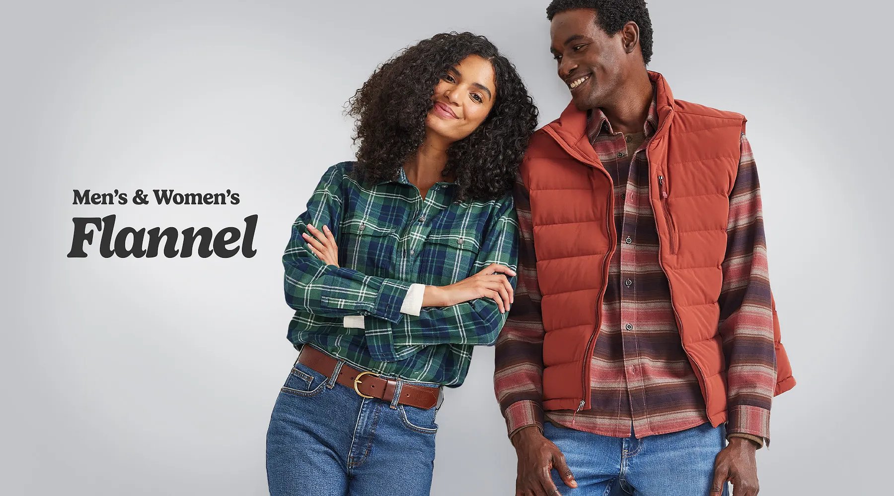 Men’s & women’s flannel. A woman wearing flannel and jeans and a man wearing a down vest over a flannel shirt.