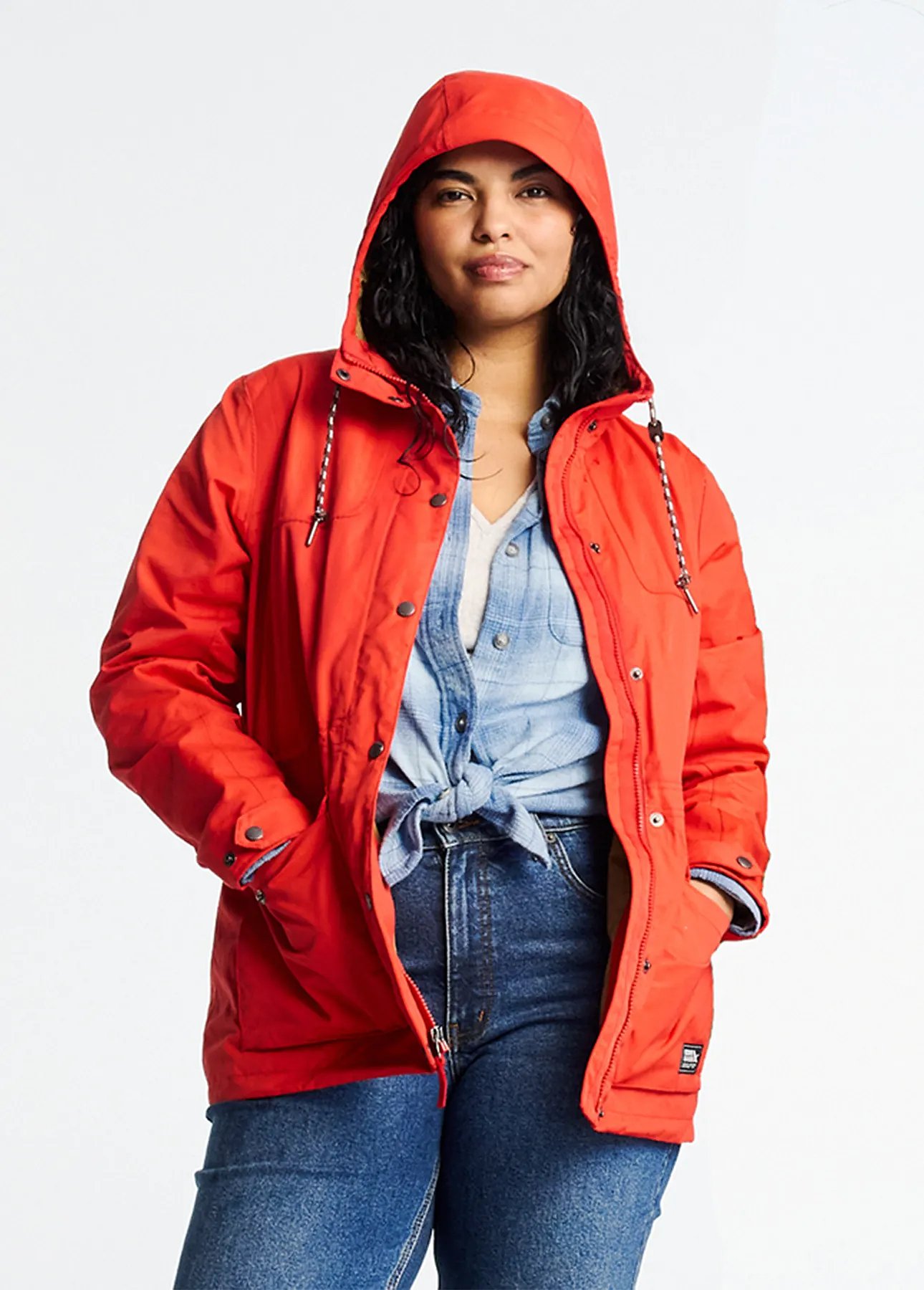 A women wearing an unzipped rain jacket with the hood up.