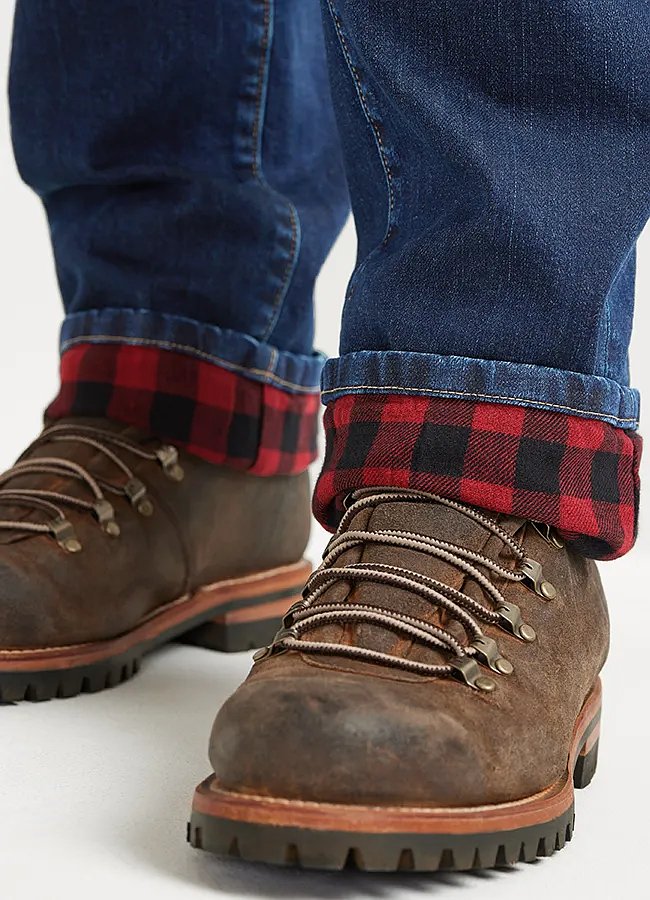 Flannel lined jeans with the hem rolled up showing plaid lining. Worn with boots.