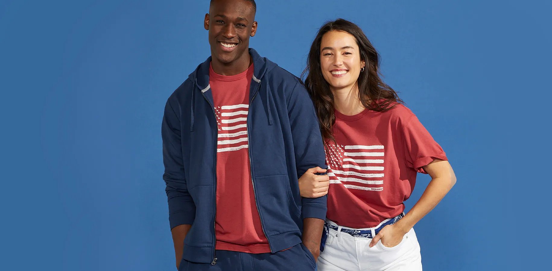 A man and a women standing together against a blue background
